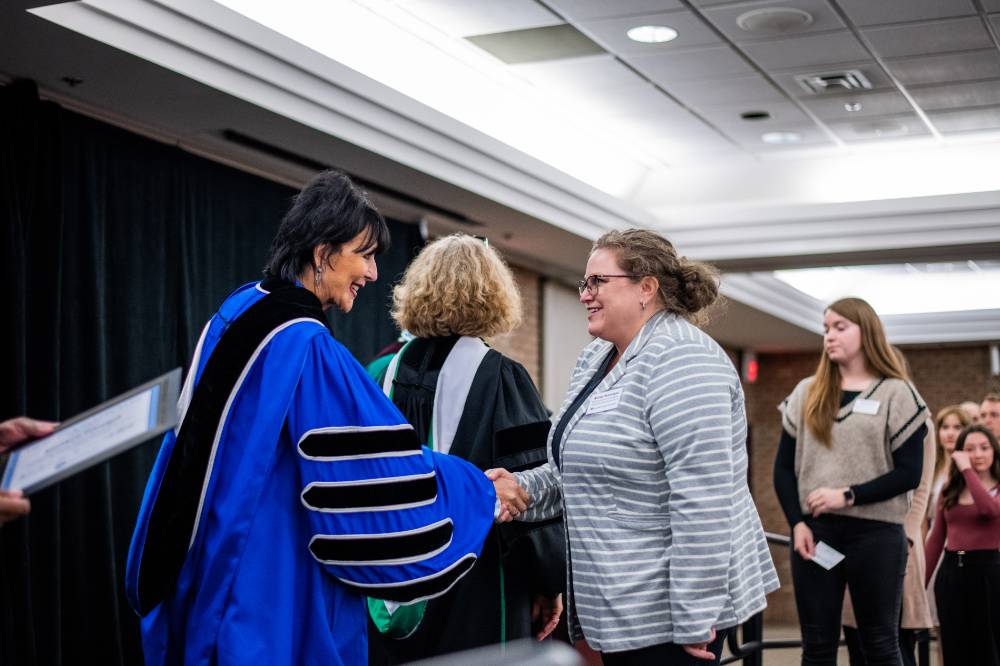 Student shaking hand with faculty 10